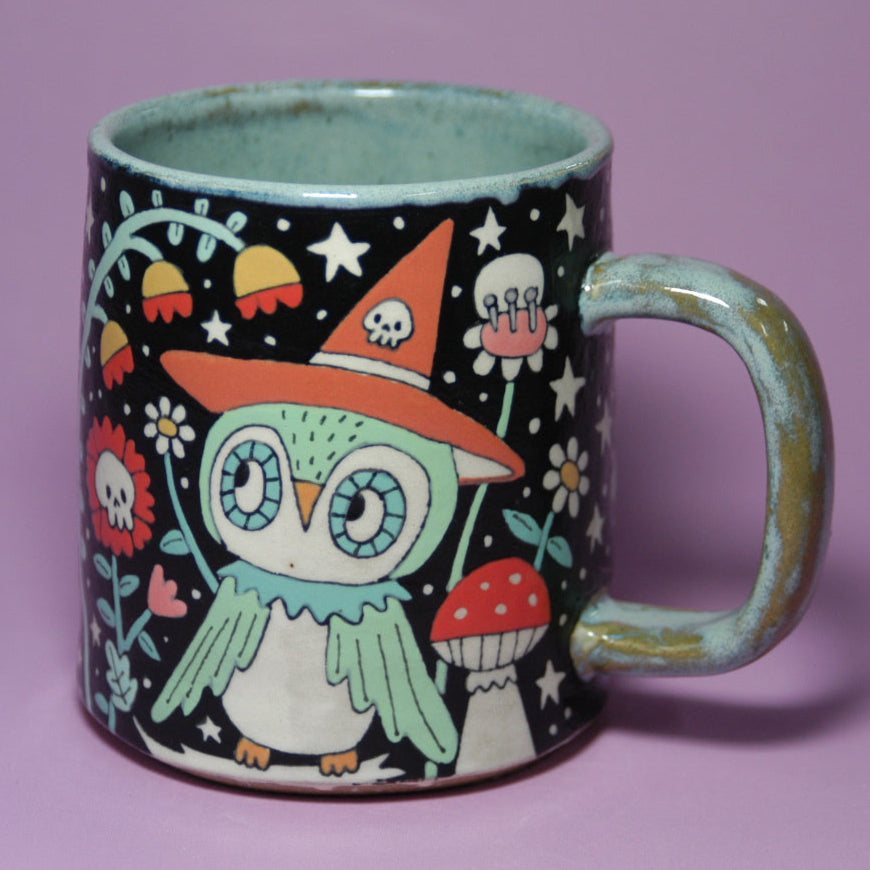 Mug with a colorful owl design on a purple background