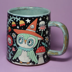Mug with a colorful owl design on a purple background