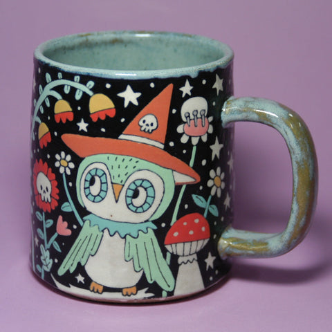Mug with a colorful owl design on a purple background