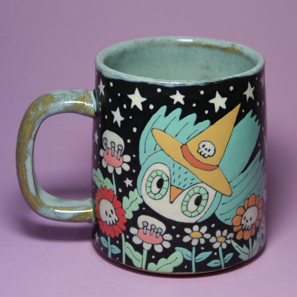 Colorful mug with owl design on a purple background