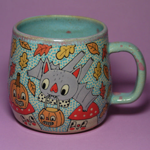 Colorful mug with cartoon designs on a purple background