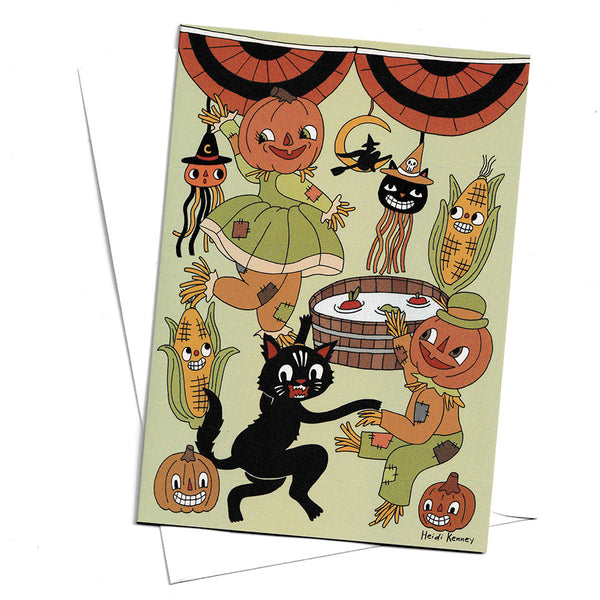 A rectangle greeting card featuring illustrations of pumpkin people, a Halloween cat and smiling corn dancing around a mint green space with other Halloween decorations.