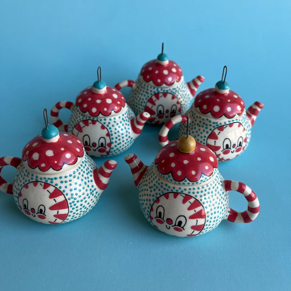 decorative teapot ornaments with polka dot patterns on a blue background