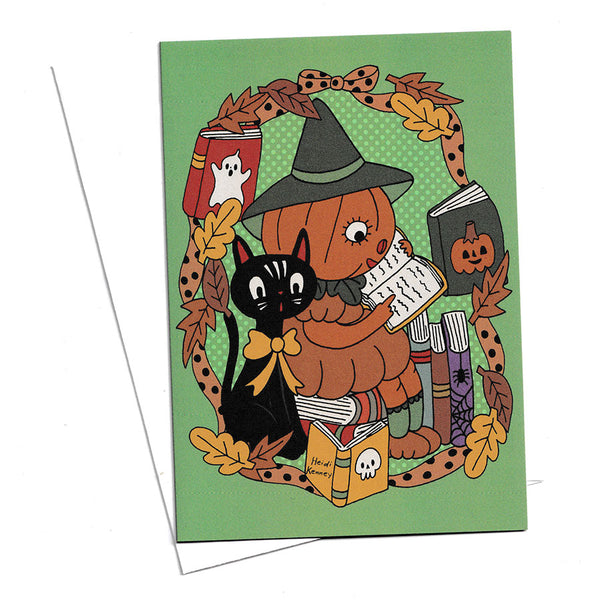 A Halloween greeting card with a green background and a whimsical illustration of a pumpkin wearing a witch hat, reading a book, with a black cat, autumn leaves, and books around it. 