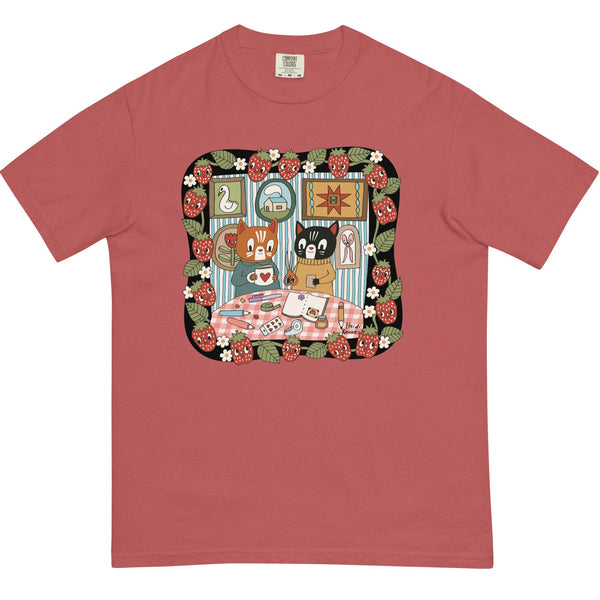Red t-shirt with a colorful graphic of animals at a table on a white background
