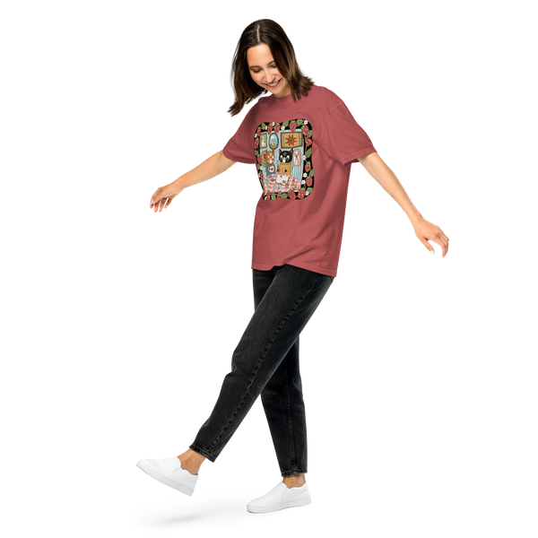 Woman wearing a red oversized t-shirt with a colorful graphic design on a white background