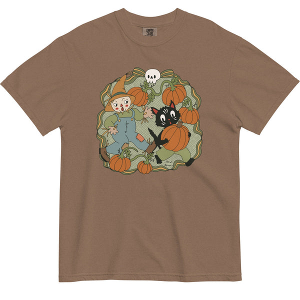 Brown t-shirt with a graphic of a scarecrow and black cat among pumpkins on a white background