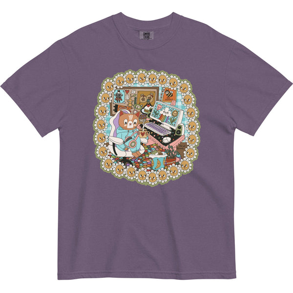 Purple t-shirt with a colorful graphic of a cat playing on a computer, surrounded by flowers.