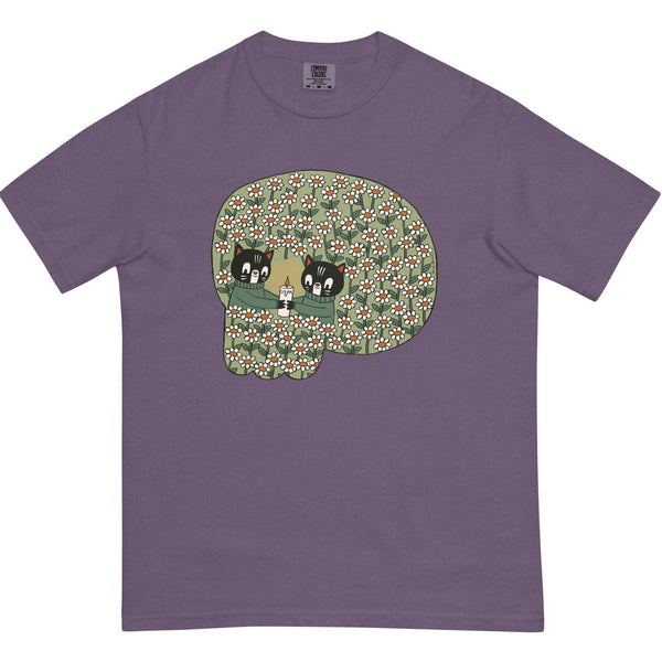 dusty purple t-shirt with a design that resembles a skull but is two illustrated cats holding a candle in a field of flowers 