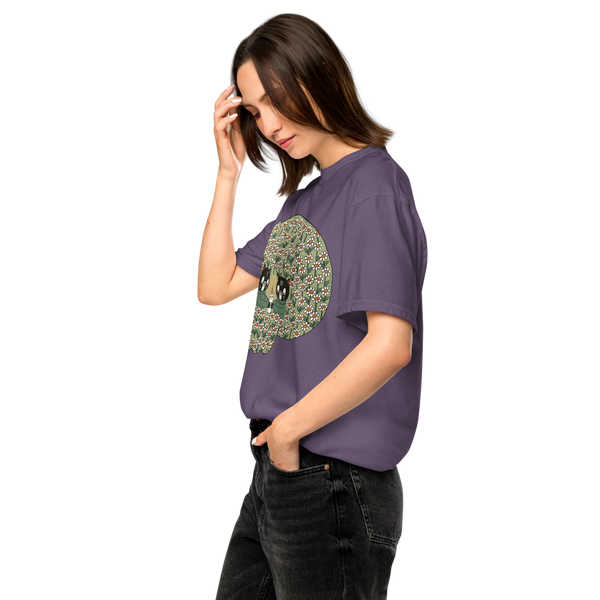 A woman wearing a purple oversized graphic t-shirt with a detailed green skull design on the front, paired with black jeans, set against a plain white background.